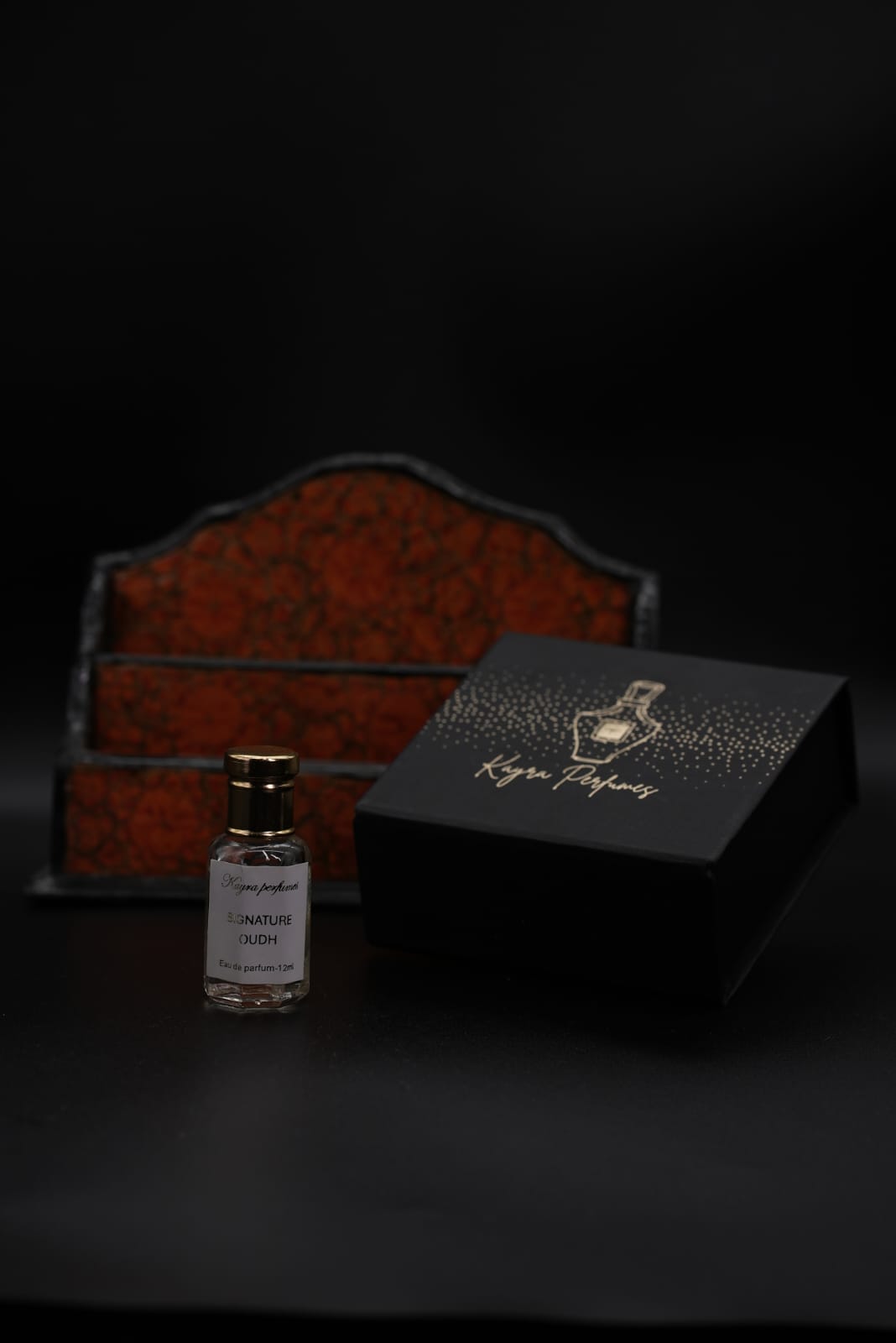 Kayra Perfumes Signature Oudh eau de parfum bottle in front of a papier-mâché Kashmiri box